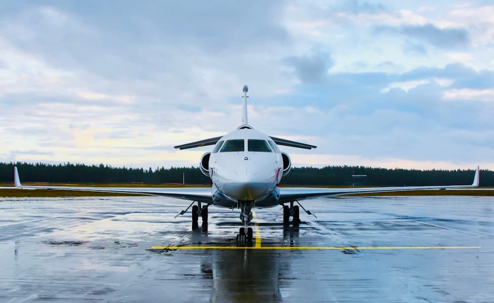 A business jet facing the camera on a wet apron